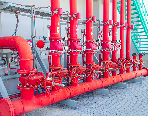 Red industrial pipes with valves